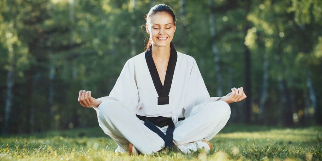Martial Arts Lessons for Adults in Carrollton TX - Happy Woman Meditated Sitting Background